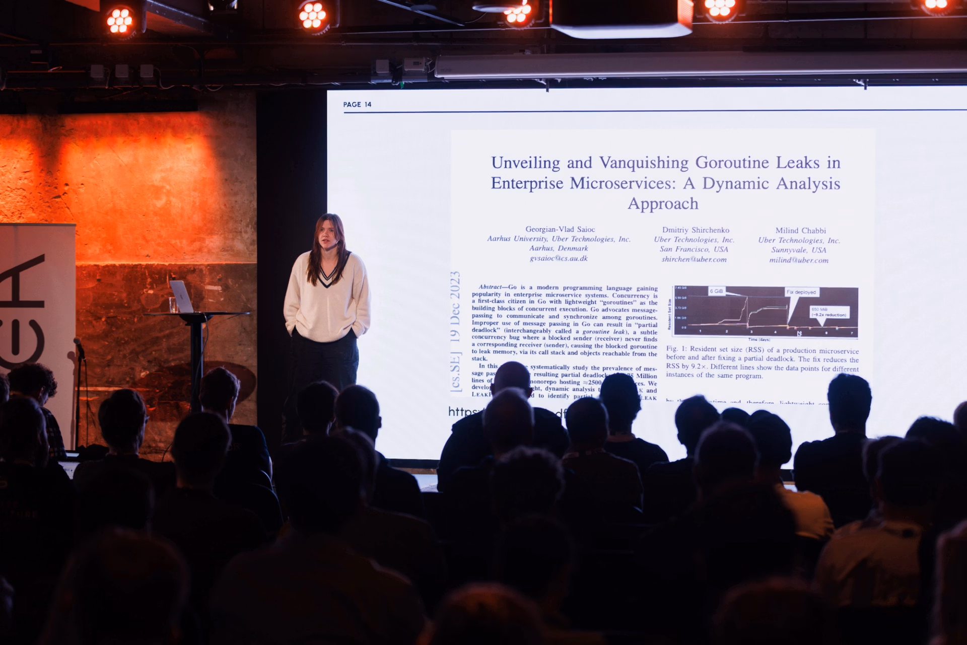 Sarah Christoff speaking on stage at a conference
